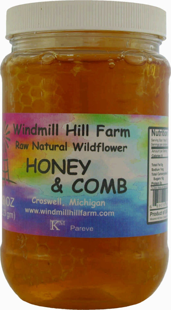 Honey & Comb - raw natural comb honey floating in a jar of wildflower honey